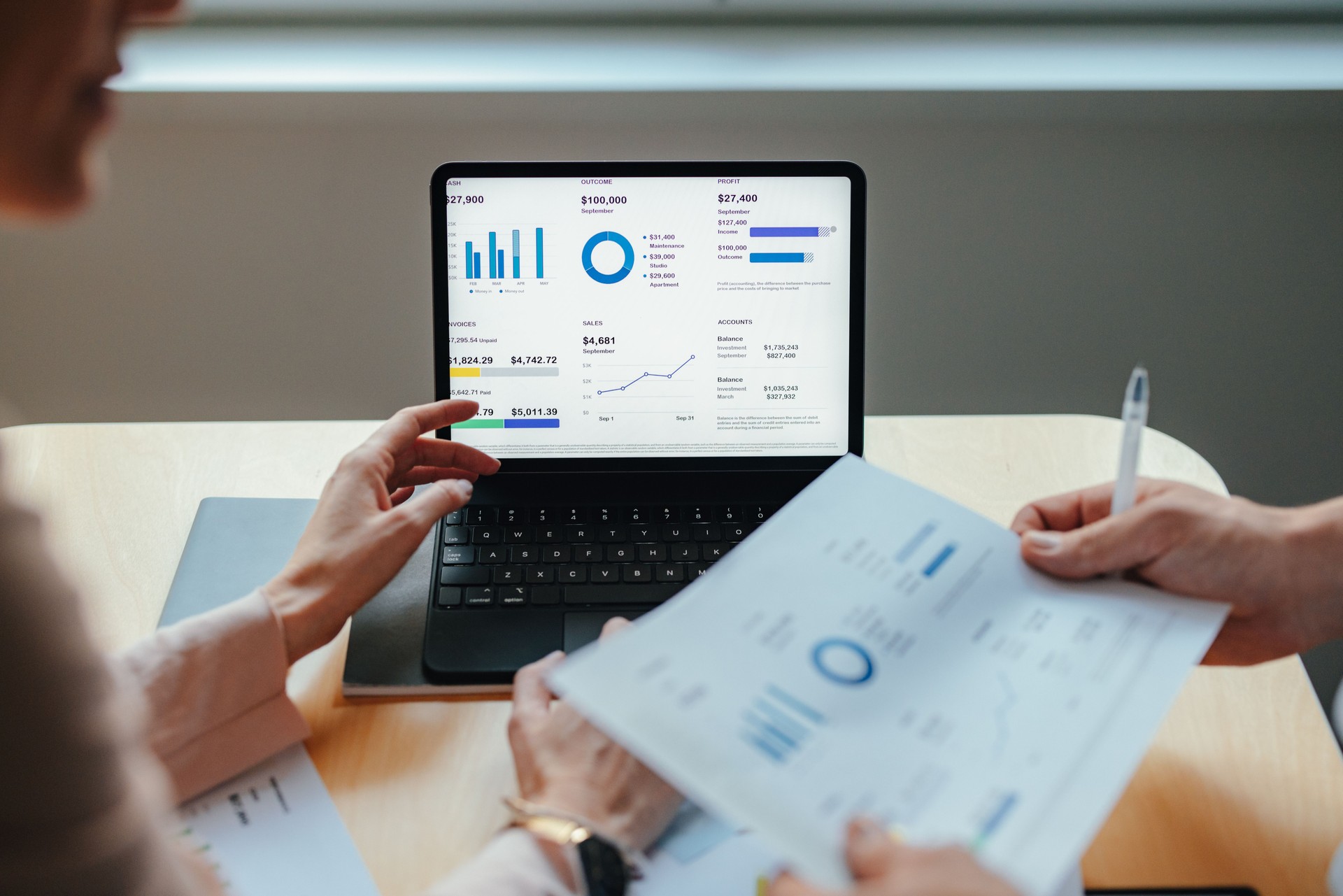 Unrecognizable Businesspeople Analyzing Business Graphs and Documents Together